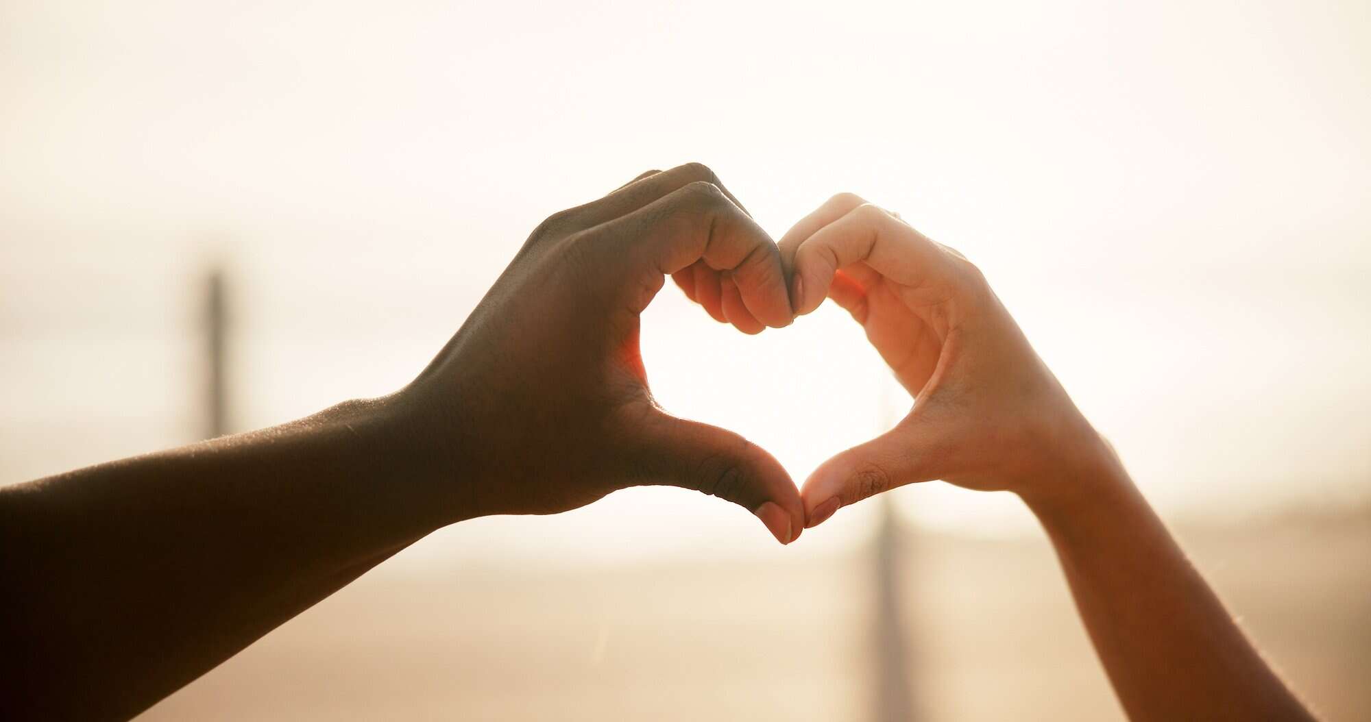 Heart, couple and hands outdoor with love, romance and bonding together with marriage on holiday. V